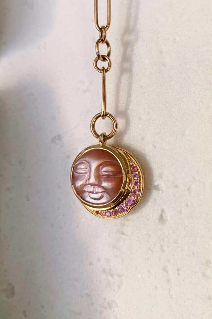 ‘Pink Moon’ pendant. Carved peach moonstone, crescent moon halo of pink sapphires, hand made chain, 9ct yellow gold